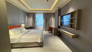a hotel room with a bed and a flat screen tv at Amaris Hotel in Al Ḩamrāʼ +38 photos