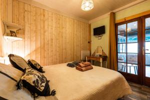 a bedroom with a bed and a tv and a window at Gite Des Lys in Monségur +11 photos