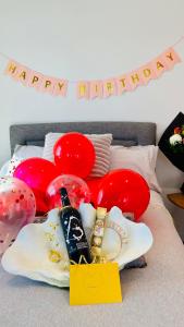 a group of balloons and shoes with a happy birthday sign at Spectacular Auckland CBD Views in Auckland +37 photos