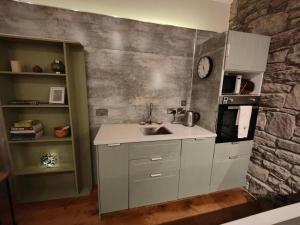 a kitchen with a sink and a stone wall at 4Guest-2Bedroom-Wifi-Parking in Deerpark