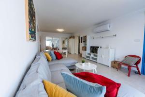 a living room with a couch and a table at Beachfront Mediterranean Escape 3bd Sea View Apartment in Pendakomo