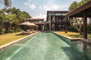 an image of a swimming pool in front of a house at Oceanfront Luxury Villa in Beraban with Private Pool in Krambitan