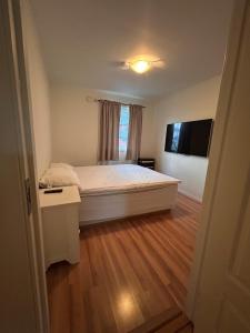 a small bedroom with a bed and a window at Cozy fjordside house, with mountain view 