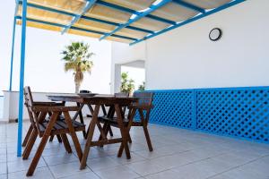 a dining room with a wooden table and chairs at Beachfront Mediterranean Escape 3bd Sea View Apartment in Pendakomo