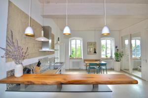 a kitchen and dining room with a wooden table at Alte Schule mit moderner Wohnung - Die Lesestube in Baustert +10 photos