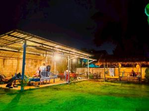 a group of people under a shed at night at Hug Pai Garden City Retreat in Pai
