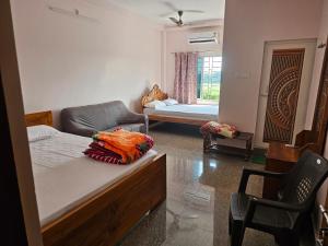 a living room with a bed and a couch at Hotel Seven Heaven in mayapur