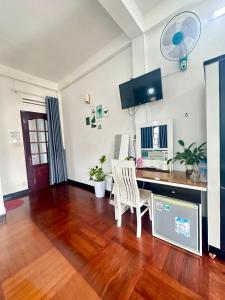 a living room with a desk with a computer on it at Dona Hotel in Da Lat +32 photos