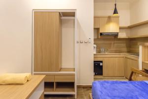 a small kitchen with a bed in a room at TwoSpaces Living at Bunda Nana Residence, Gianyar in Gianyar