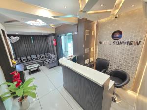 a salon with a counter and a waiting room at Hotel Sunview in Ahmedabad