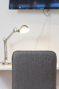 a lamp sitting on a desk next to a chair at Rainbow Studio in Haga & Linné - Prime Location in Gothenburg +42 photos