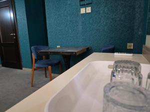 a bath tub in a room with a table and chairs at SaraSofi Hotel in Baku +154 photos