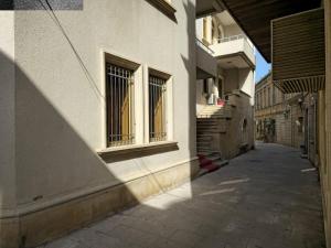 an alley with two windows and a building at SaraSofi Hotel in Baku