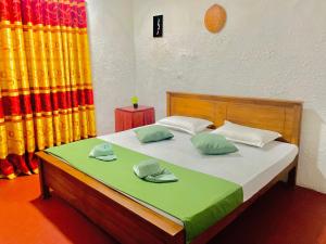 a bedroom with a bed with two hats on it at The Hiddenway Weligama in Weligama +13 photos