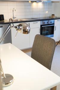 a kitchen with a sink and a table with a chair at Rainbow Studio in Haga & Linné - Prime Location in Gothenburg