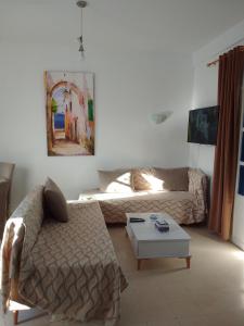 a living room with a couch and a coffee table at tagermess 1 in Midoun