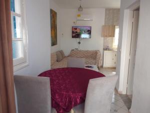 a room with a table and chairs and a living room at tagermess 1 in Midoun