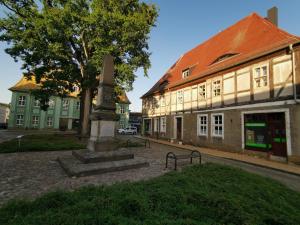 a monument in the middle of a street next to a building at Forsthaus Nicolai in Pretzsch