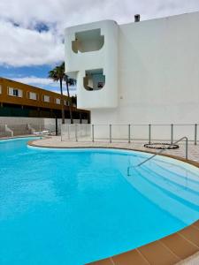 a large swimming pool in front of a building at Elixir Estate in Antigua