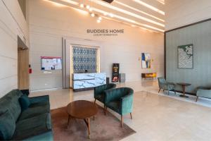 a lobby with couches and chairs in a building at Private Cinema Apartment By Buddies Home in Greater Noida