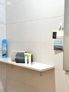 a bathroom with a shelf with towels on it at Elixir Estate in Antigua