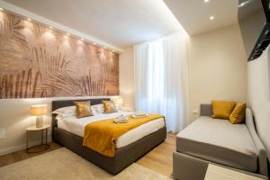 a bedroom with a bed and a chair in it at Cherubini Palace Thematic Apartment in Florence