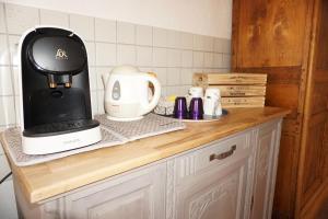 a kitchen counter with a coffee maker and a mixer at La Ferme de la Bergerie 