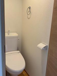 a bathroom with a toilet and a roll of toilet paper at 新宿区の新築木造アパート-駅から徒歩5分 in Tokyo +12 photos