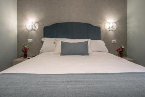 a bedroom with a large bed with a blue headboard at Roma suite hotel in Rome