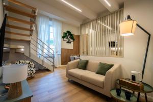 a living room with a couch and a staircase at Cherubini Palace Thematic Apartment in Florence +89 photos
