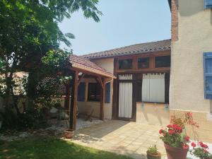an outside view of a house with a patio at Gite de la chapelle in Nogaro