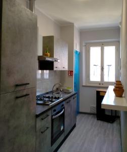 a kitchen with a stainless steel stove and a window at WoW San Miniato in San Miniato