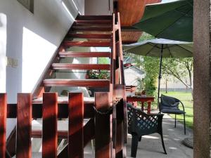 a staircase in a house with a table and an umbrella at Tarčin Village Retreat in Tarčin