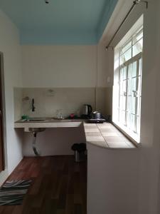 a kitchen with a sink and a window at Spring Grove B&B in Jowai
