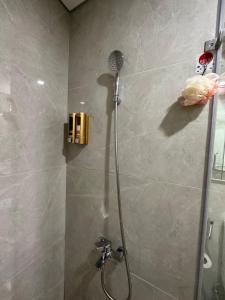 a shower with a shower head in a bathroom at Masteri Pearl Apartment - Luxury view in Ocean Park 1 in Gia Lâm Pho