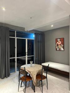 a dining room with a table and chairs and a bed at kandy hill villa in Kandy