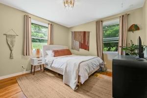 a bedroom with a bed and a tv and windows at Bachelorette Retreat in Nashville in Providence