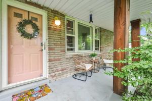 a porch with a pink door and chairs and a table at Bachelorette Retreat in Nashville in Providence