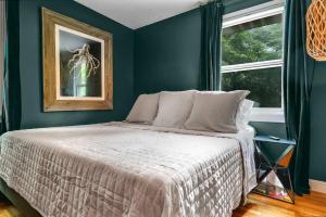a bedroom with a bed with green walls and a window at Bachelorette Retreat in Nashville in Providence +34 photos