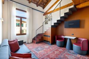 a room with a couch and a table and a staircase at Eurostars Residenza Cannaregio in Venice