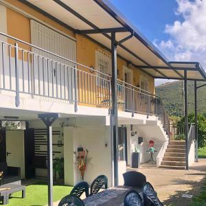 a house with a balcony with a table and chairs at Casa Mari Carmen in Salas