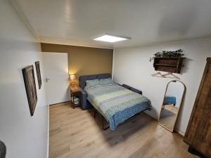 a bedroom with a bed and a chair in it at Bed & Breakfast Twekkelo in Enschede