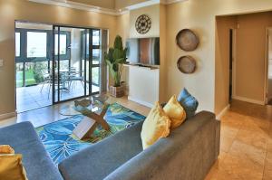 a living room with a couch and a table at Ellefsen Golf Suite 108, Langebaan, 4-sleeper in Langebaan