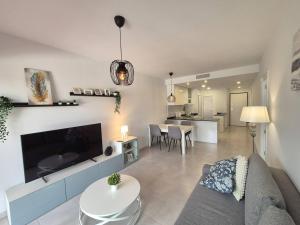 a living room with a couch and a table at Casa ariella 164 in San Juan de los Terreros
