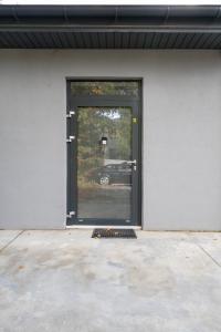 a door to a garage with a car through it at Łódź Urban Serenity Studio #11 by BookingHost in Łódź