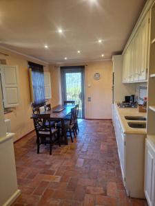 a kitchen with a table and chairs in a room at Mammolino - Medieval Mini-villa with Jacuzzi and stunning views in Lucca +12 photos