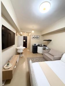 a hotel room with a bed and a living room at Condo in Cagayan de Oro City in Cagayan de Oro