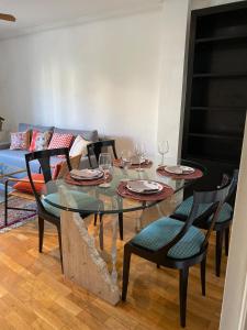 a dining room with a glass table and chairs at Lovely 2 bedrooms apartment main square Plasencia in Plasencia