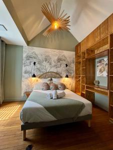 Un dormitorio con una cama grande con una lámpara de araña. en Villa Sirey & SPA - Design - Centre-ville - Jacuzzi & Sauna, en Brive-la-Gaillarde
