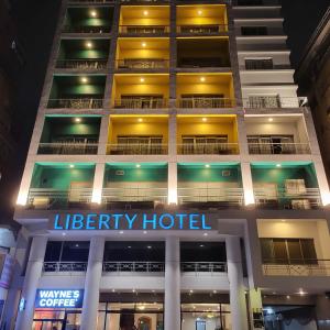 a building with a library hotel lit up at night at Liberty Hotel Saigon Parkview in Ho Chi Minh City